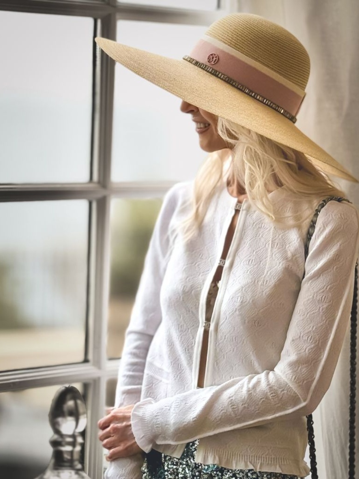 Lee Davies — Maison Michel wide-brim straw hat, white openwork knit and Chanel quilted bag · evidence